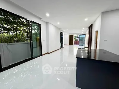 Spacious modern living room with large windows and sleek flooring