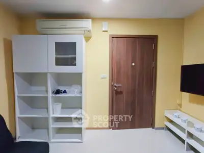 Modern living room with sleek storage and wall-mounted TV