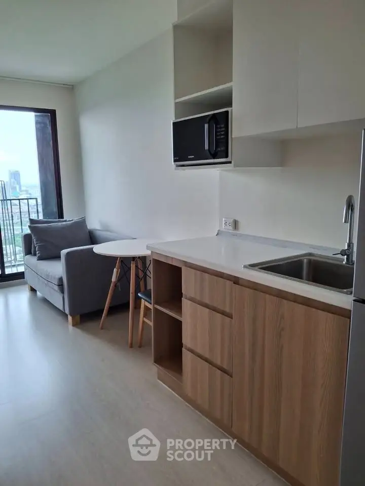 Modern apartment interior with compact kitchen and cozy living area