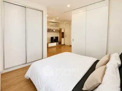 Modern bedroom with sleek design, featuring built-in wardrobe and cozy ambiance.