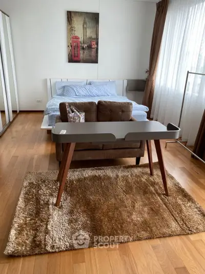 Spacious bedroom with modern decor and natural light