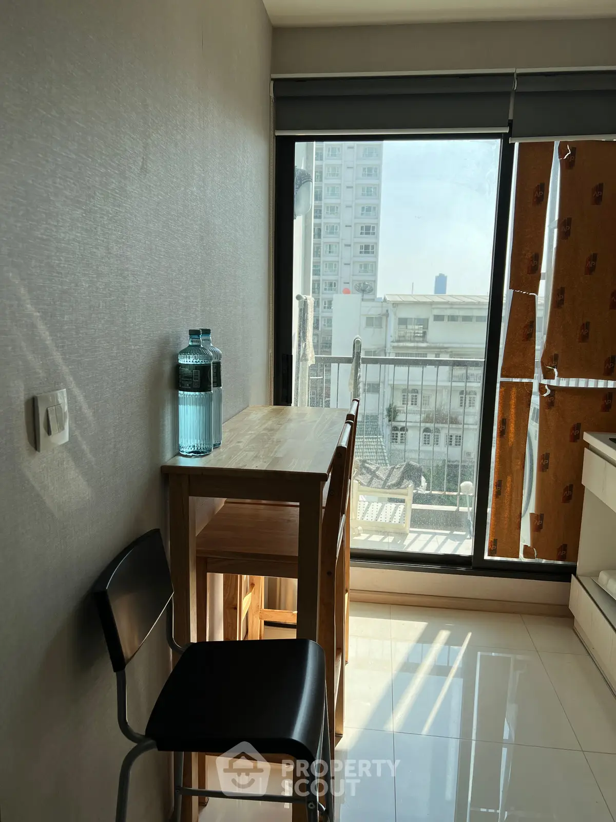 Cozy dining nook with natural light and city view, perfect for intimate meals.