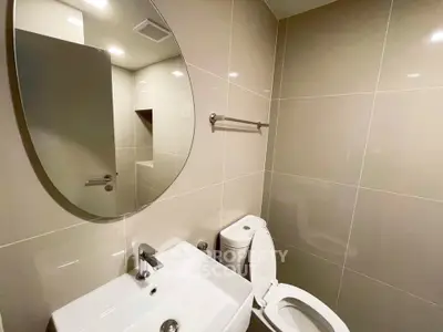 Modern bathroom with sleek fixtures and neutral tiles