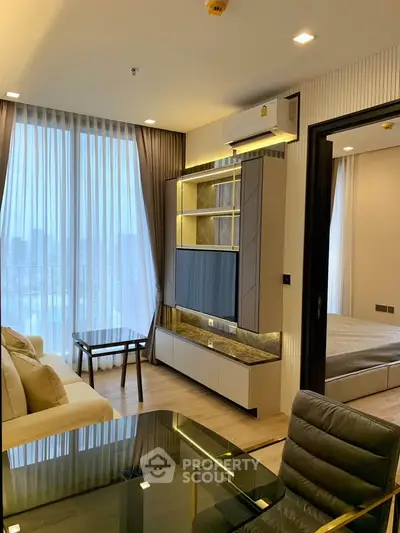 Modern living room with floor-to-ceiling windows and stylish furniture in a high-rise apartment.