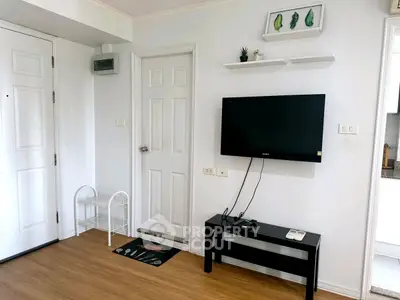 Modern living room with wall-mounted TV and minimalist decor