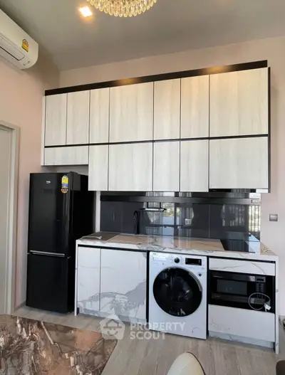 Modern kitchen with sleek cabinets, integrated appliances, and stylish marble countertops.