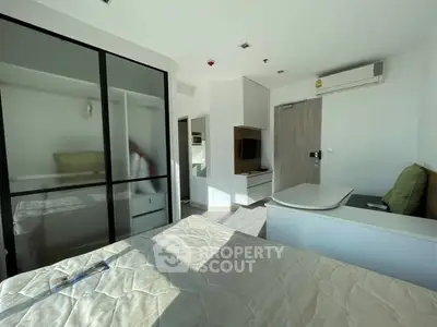 Modern bedroom with built-in wardrobe and air conditioning unit