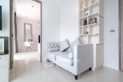 Modern living room with stylish sofa and elegant decor in a bright, minimalist apartment.