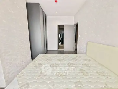 Spacious bedroom with modern design and ample natural light.