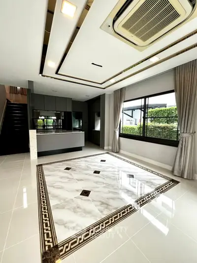 Luxurious modern living room with elegant marble flooring and large windows offering garden views.