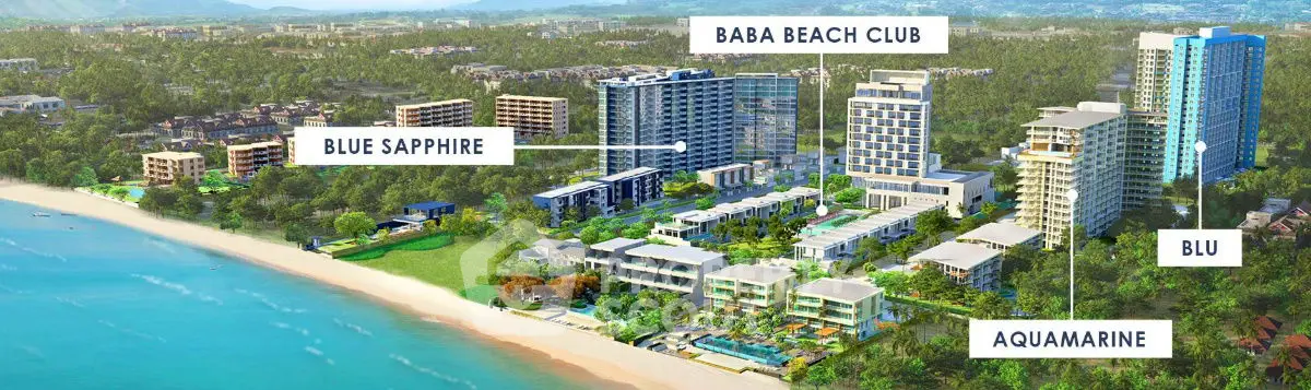 Luxurious beachfront real estate development with modern high-rise buildings and lush greenery.