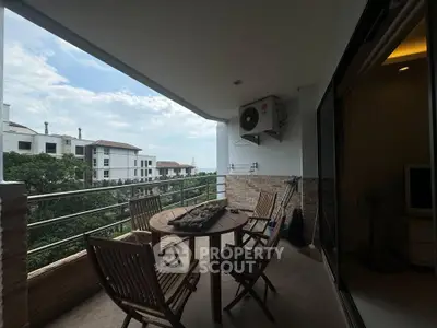 Spacious balcony with outdoor seating and scenic view in modern apartment