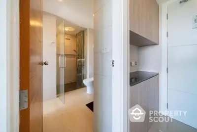 Modern bathroom with glass shower and sleek wooden cabinetry