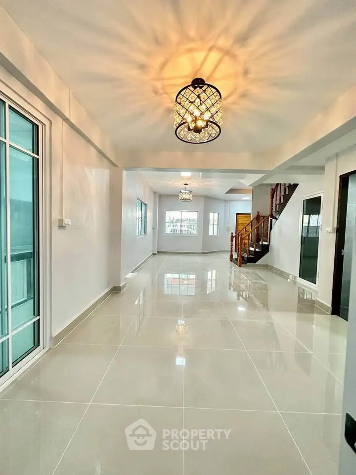 Spacious modern living room with elegant lighting and glossy tile flooring