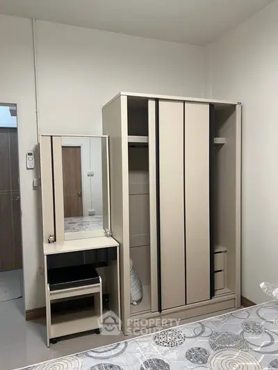 Cozy bedroom with modern wardrobe and dressing table in a stylish apartment.