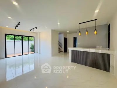 Spacious modern living room with open layout and stylish lighting, perfect for entertaining.