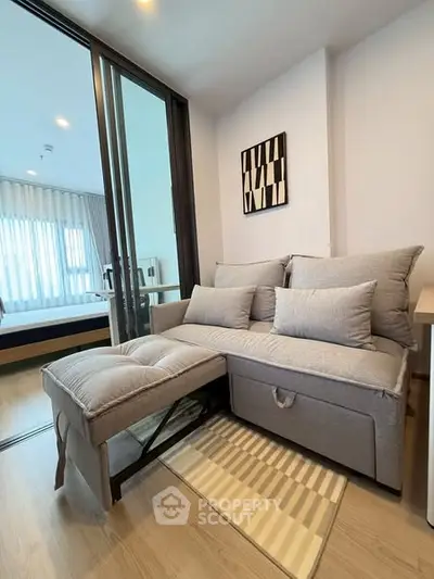 Modern living room with stylish gray sofa and natural light