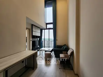 Spacious modern living room with high ceilings and large windows offering a stunning view.