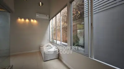 Modern interior with large windows and sleek lighting, perfect for urban living.