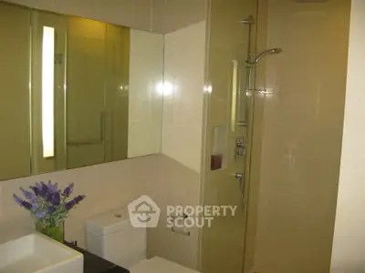 Modern bathroom with sleek shower and elegant fixtures in a contemporary apartment.