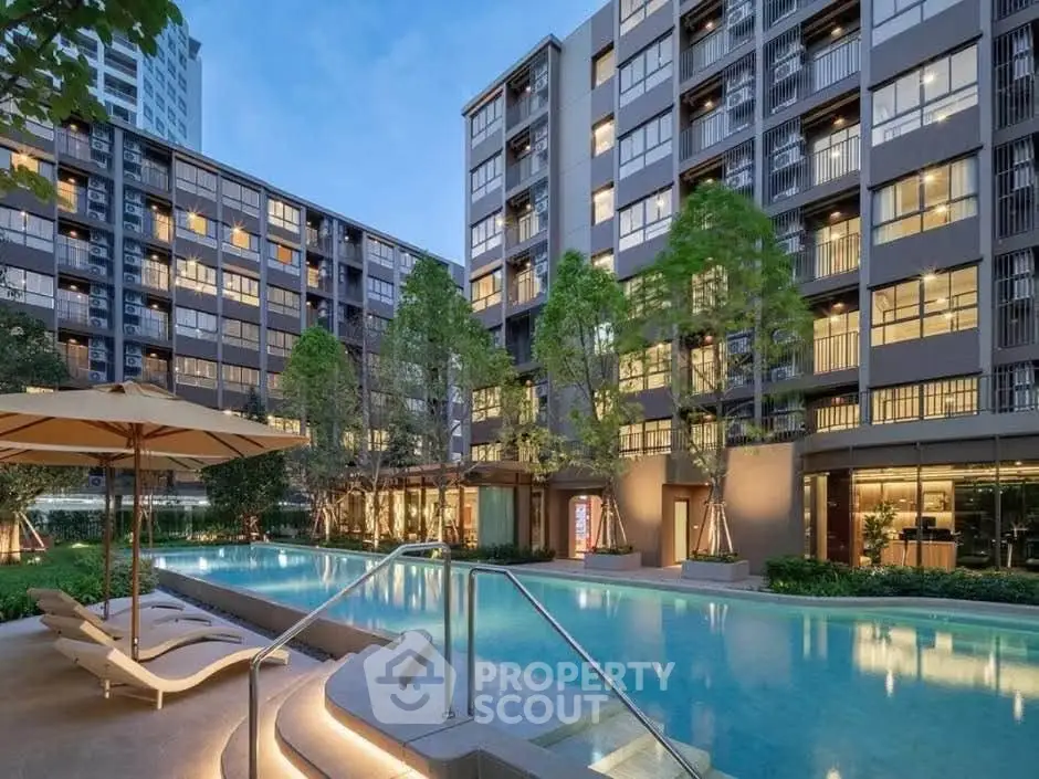 Luxurious apartment complex with a stunning pool and modern architecture, perfect for urban living.