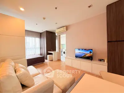 Modern studio apartment with open layout, featuring cozy living area and compact kitchen.