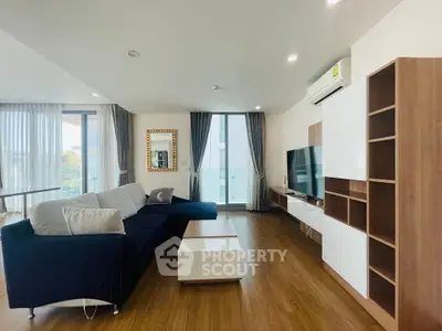 Spacious modern living room with sleek furniture and large windows