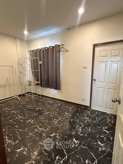 Spacious room with elegant marble flooring and modern curtain design