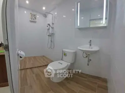 Modern bathroom with sleek fixtures and wooden tile flooring