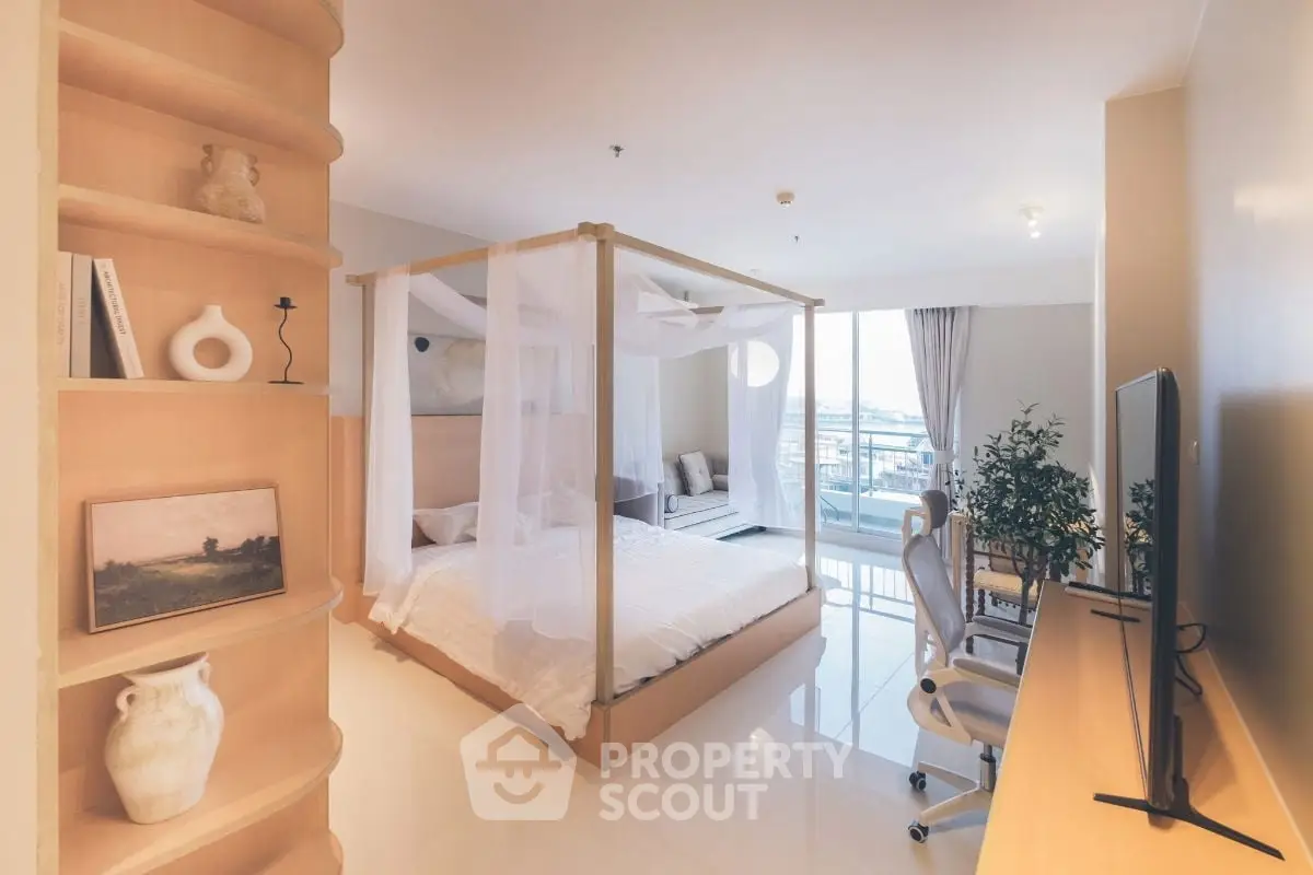 Spacious bedroom with canopy bed and modern decor, featuring a large window with a view.