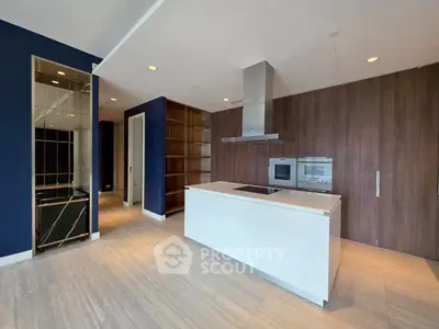 Modern kitchen with sleek design, featuring an island and built-in oven, perfect for culinary enthusiasts.