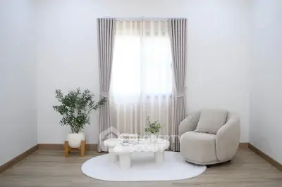 Minimalist living room with cozy armchair, stylish coffee table, and elegant curtains.