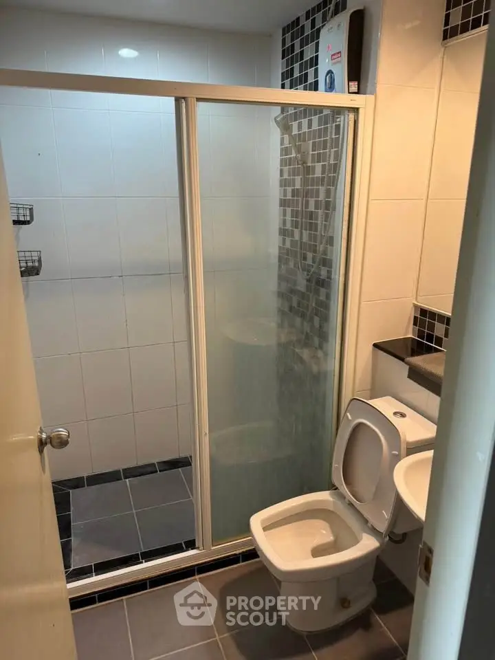 Modern bathroom with glass shower enclosure and sleek tile design