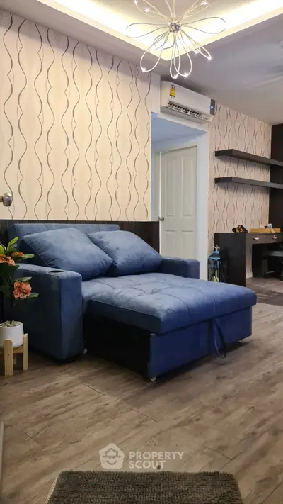Stylish living room with modern blue sofa and chic lighting