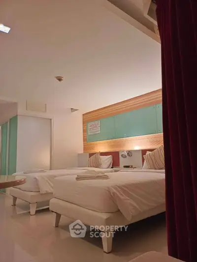 Modern twin bedroom with stylish decor and ambient lighting