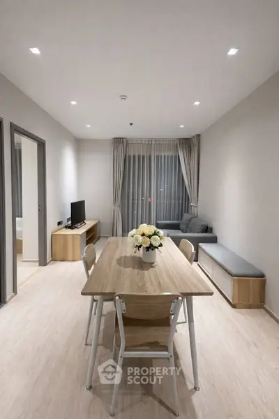 Modern living room with sleek furniture and elegant decor in a cozy apartment setting.