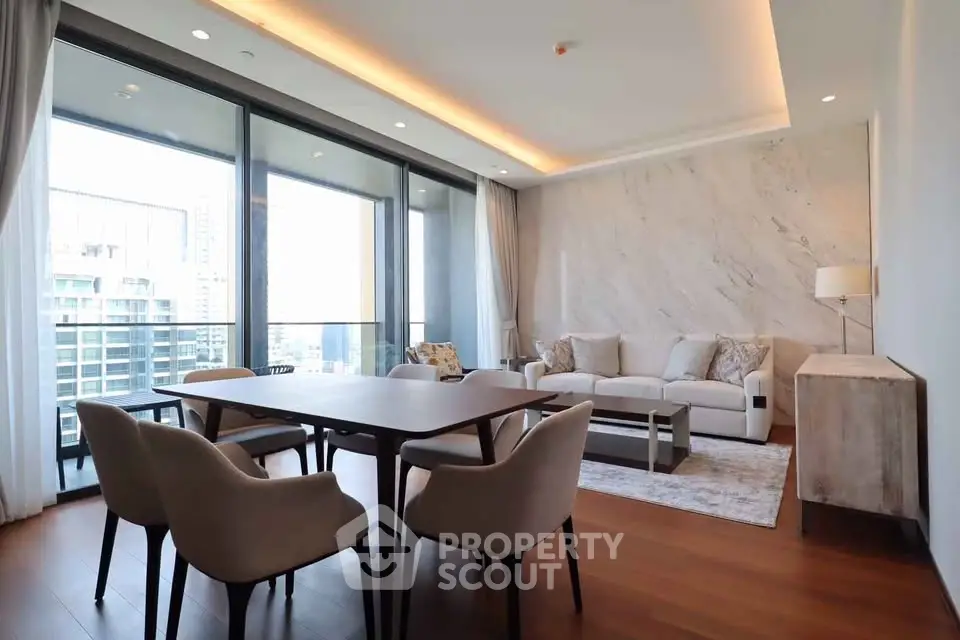 Luxurious modern living room with large windows and elegant dining area in high-rise apartment.
