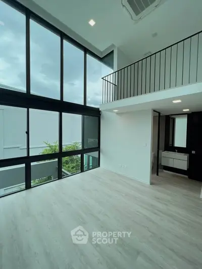 Spacious modern living room with high ceilings and large windows