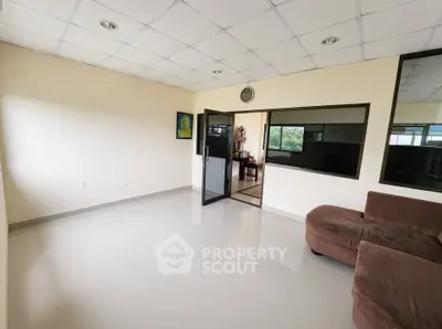 Spacious living room with modern design and large windows for natural light.