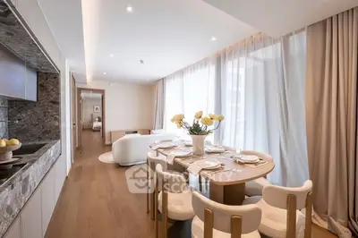 Luxurious open-plan living and dining area with elegant decor and natural light.