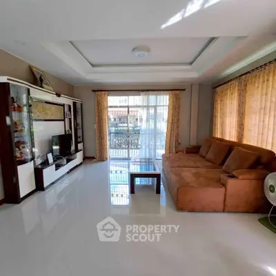 Spacious living room with modern furniture and large windows for natural light.