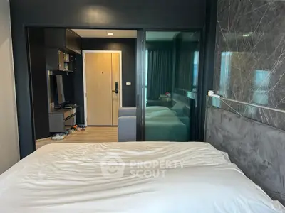 Modern studio apartment with sleek design and cozy bedroom area