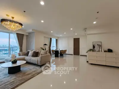 Luxurious modern living room with elegant chandelier and stunning city view.