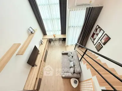 Modern loft-style living room with high ceilings and elegant decor
