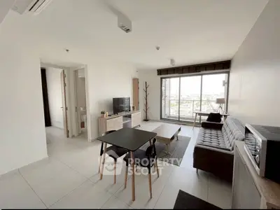 Modern living room with stylish furniture and large windows offering a great view.