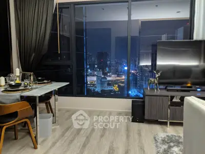 Modern living room with city view, stylish decor, and large windows for natural light.