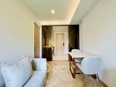 Modern living room with cozy sofa and dining area in open layout apartment