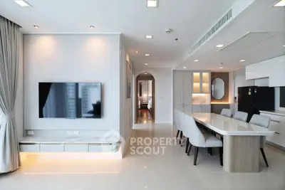Modern open-plan living room and kitchen with sleek design and ample natural light.
