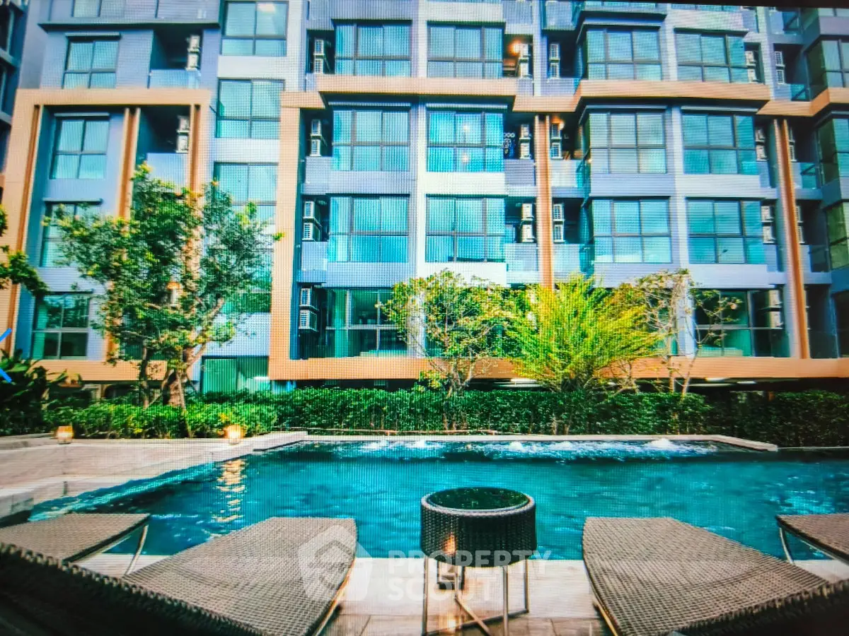 Luxurious apartment building with poolside view and modern architecture