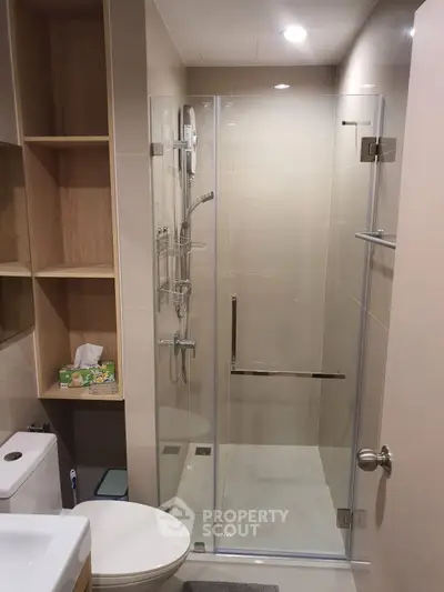 Modern bathroom with glass shower enclosure and sleek fixtures